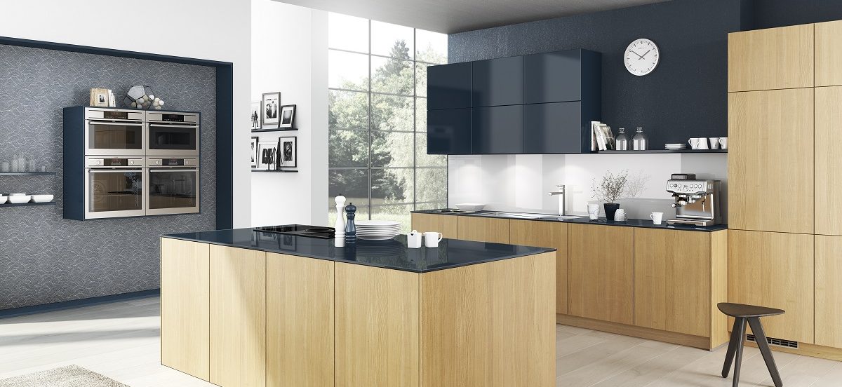 modern handleless kitchen without toe-kick in light oak wood and contrasting high gloss navy blue finish